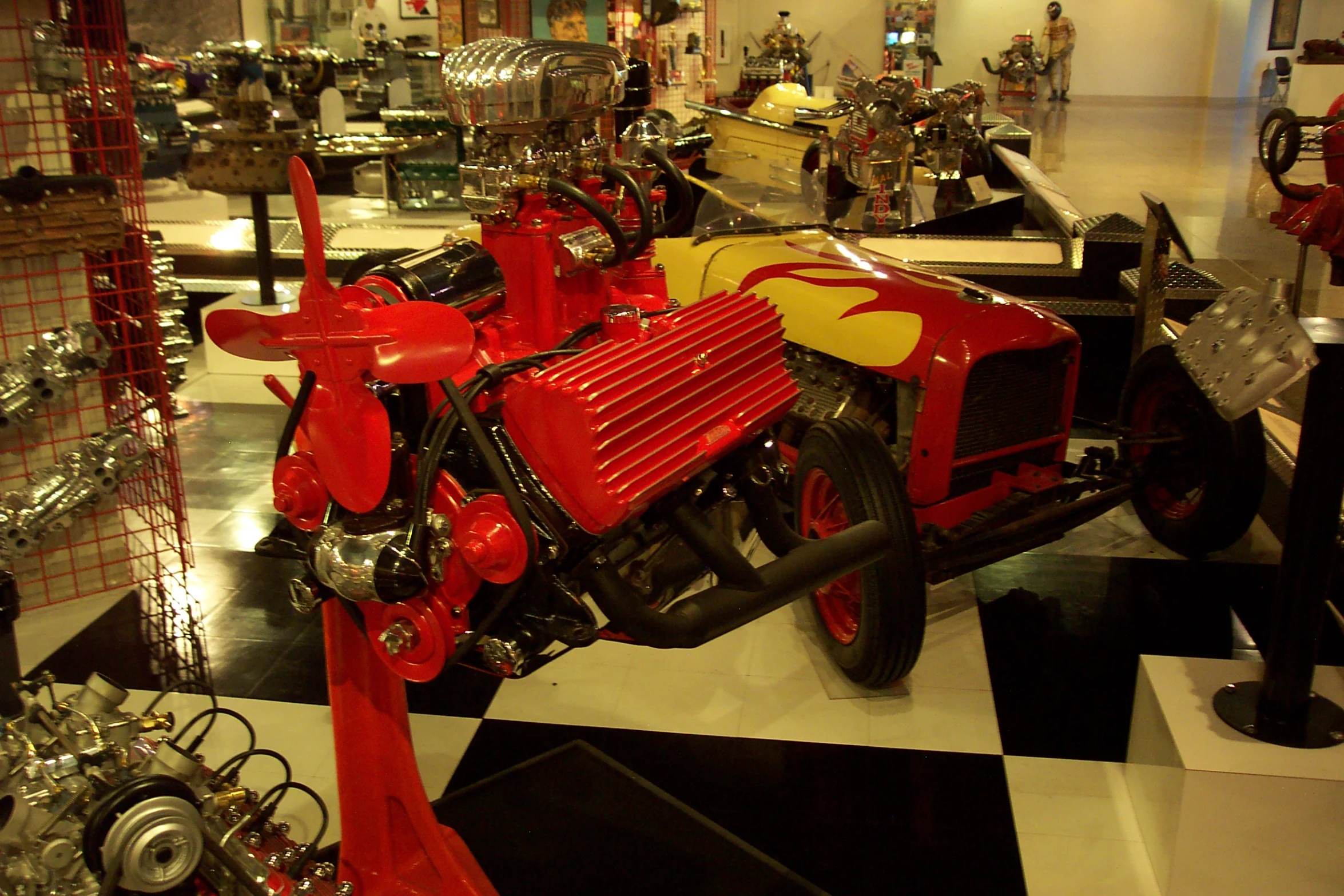 a red motor bike is parked inside of a building