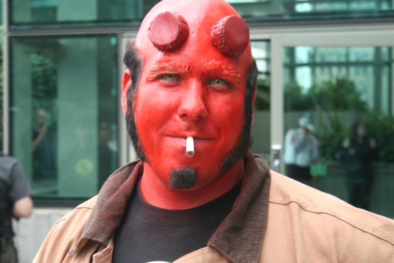 a man with red paint on his face and nose