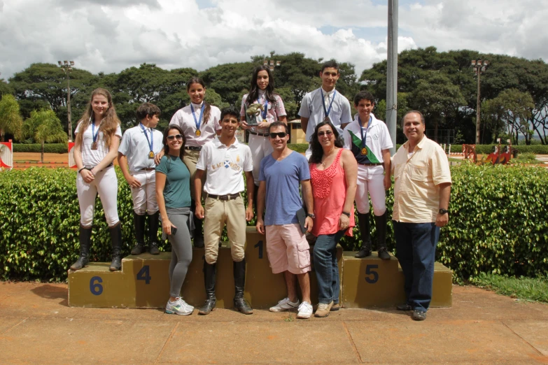 the men and women are standing on a podium