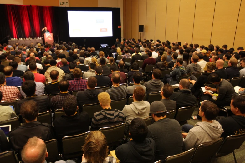 a large group of people sitting in front of a crowd