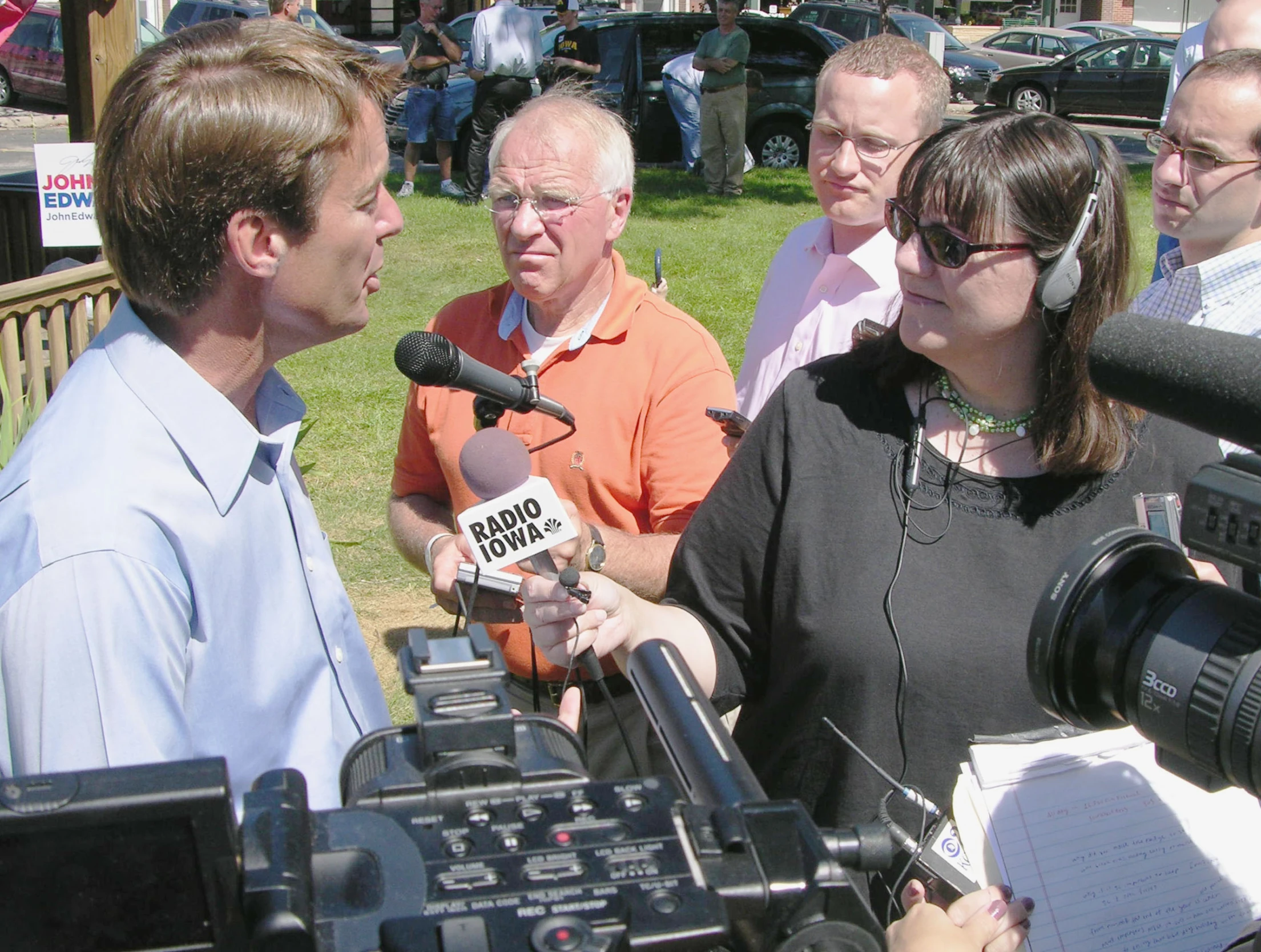 a person that is standing in front of some microphones