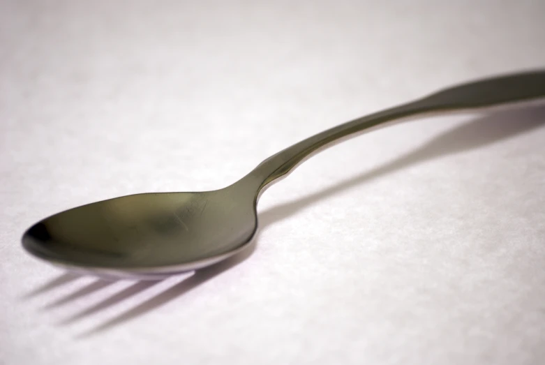 a spoon that has been placed over a white table