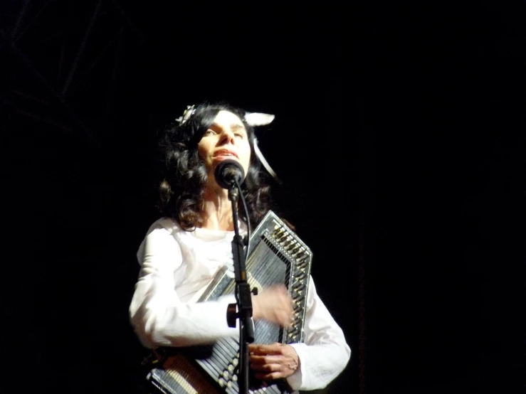 a woman standing behind a microphone on a stage