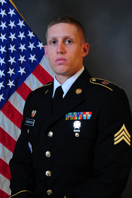 military man in uniform with american flag behind him