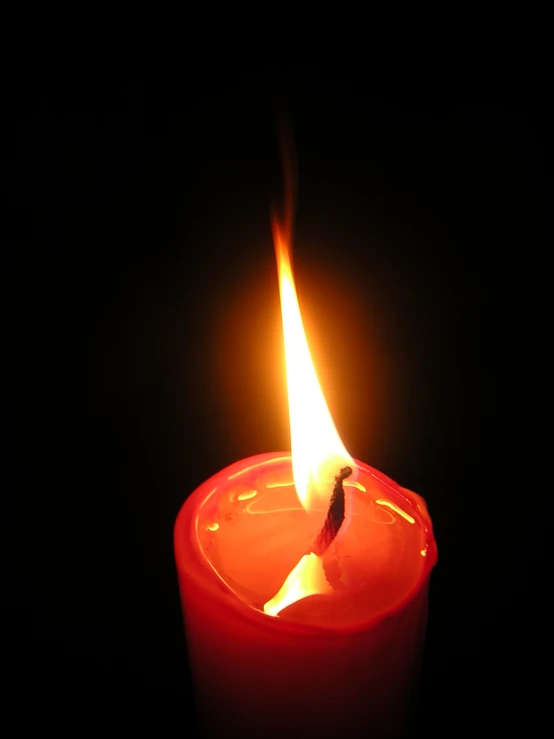 a single candle with one lit on the end