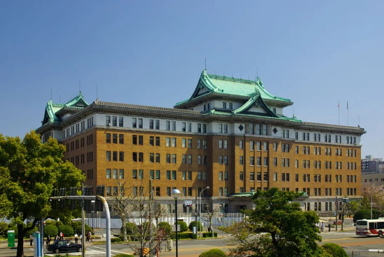 a building in a city with a green top