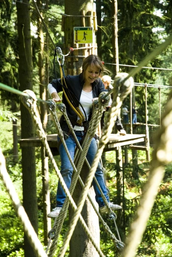 a girl on a rope course in the forest