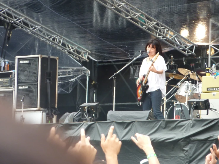 the young man stands on the stage while speaking to the crowd