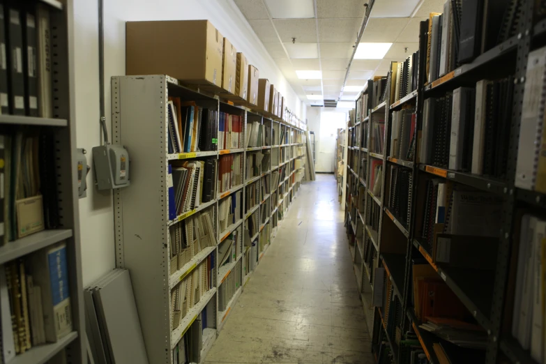 many books on shelves in an empty liry
