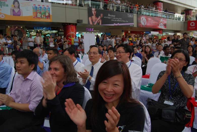 a crowd of people sitting in a crowded mall