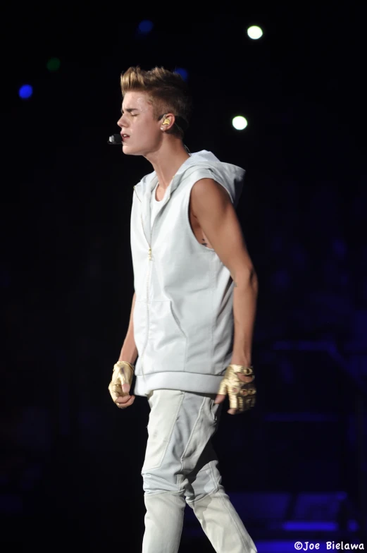 a young man is walking and wearing all white