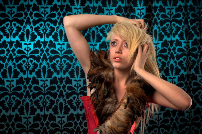 a woman in a brown feather boa is holding a red chair