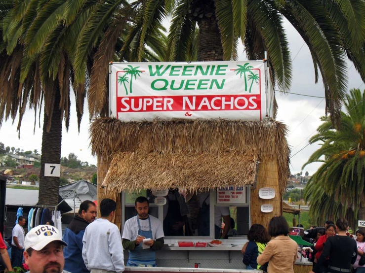 a crowd of people are standing around a vendor