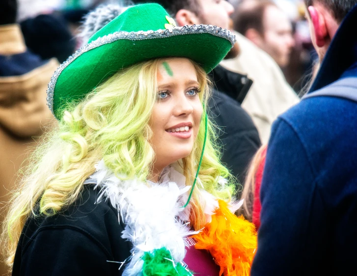 the blonde woman is dressed up in green and white