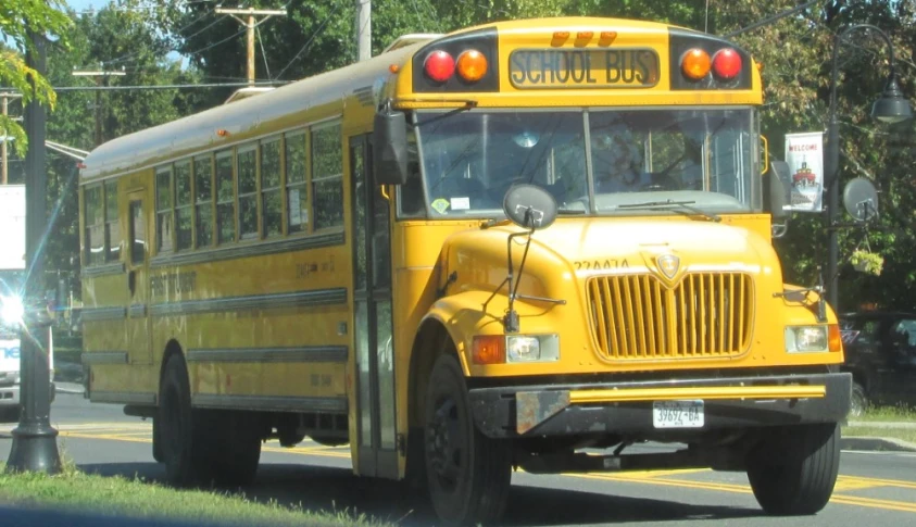 a school bus is parked next to a curb