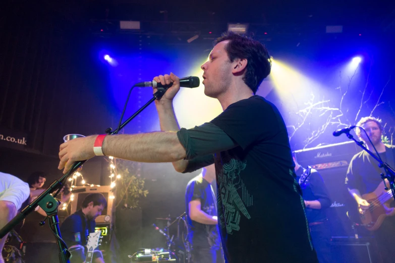 a band of young men are performing on stage