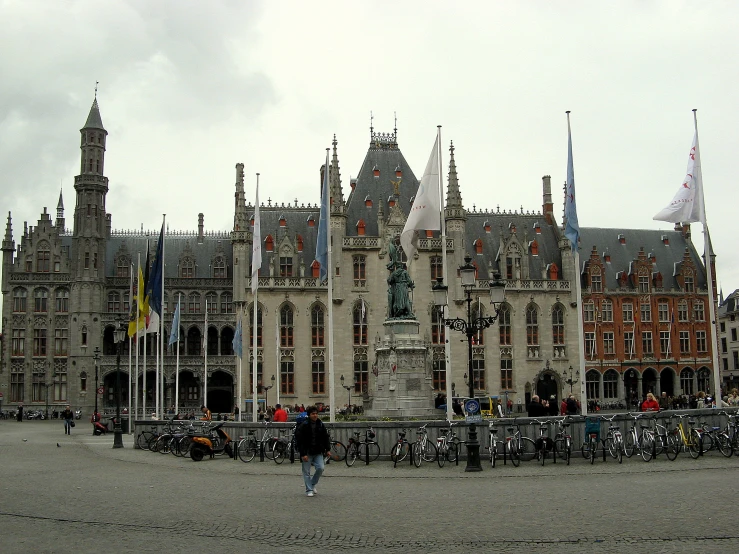 a huge old building with a lot of flags flying in the air