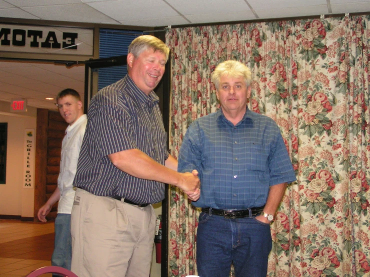 a couple of men standing around each other