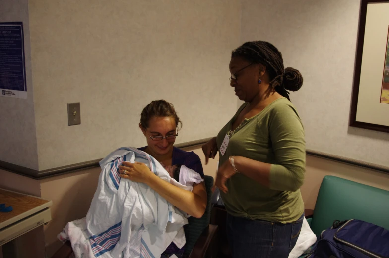 two women are trying to unpack a bag