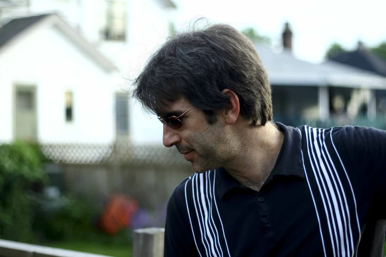 a man with a brown hair wearing sunglasses and a black shirt