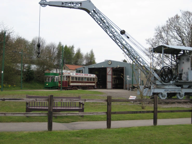 the crane is moving soing over a truck