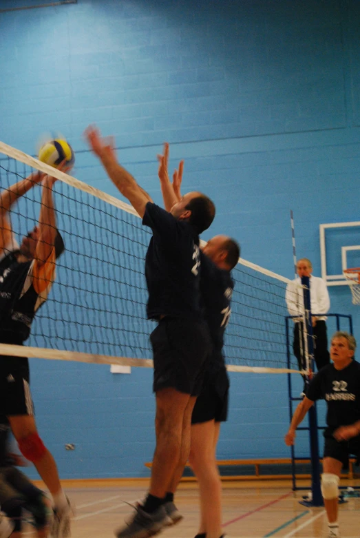 a group of young people playing a game of volleyball