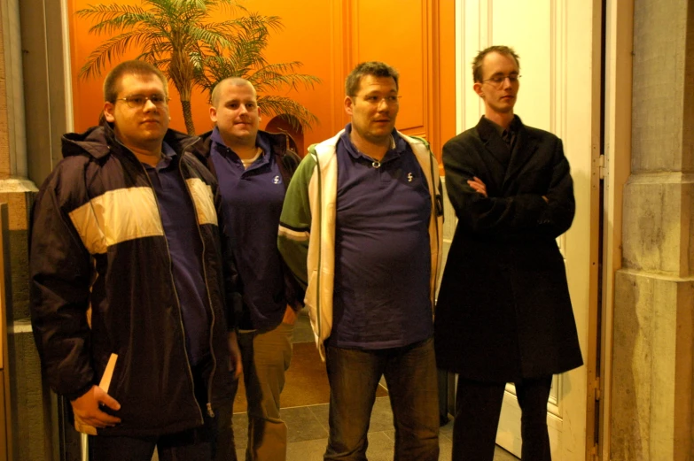 a group of men standing in an elevator together