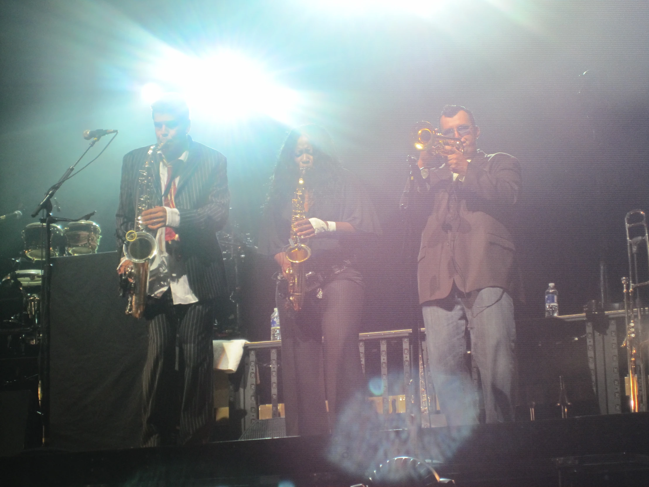 a group of men standing on top of a stage with microphones