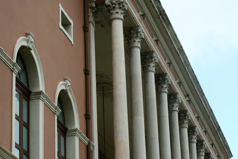 a red brick building with large pillars on each side