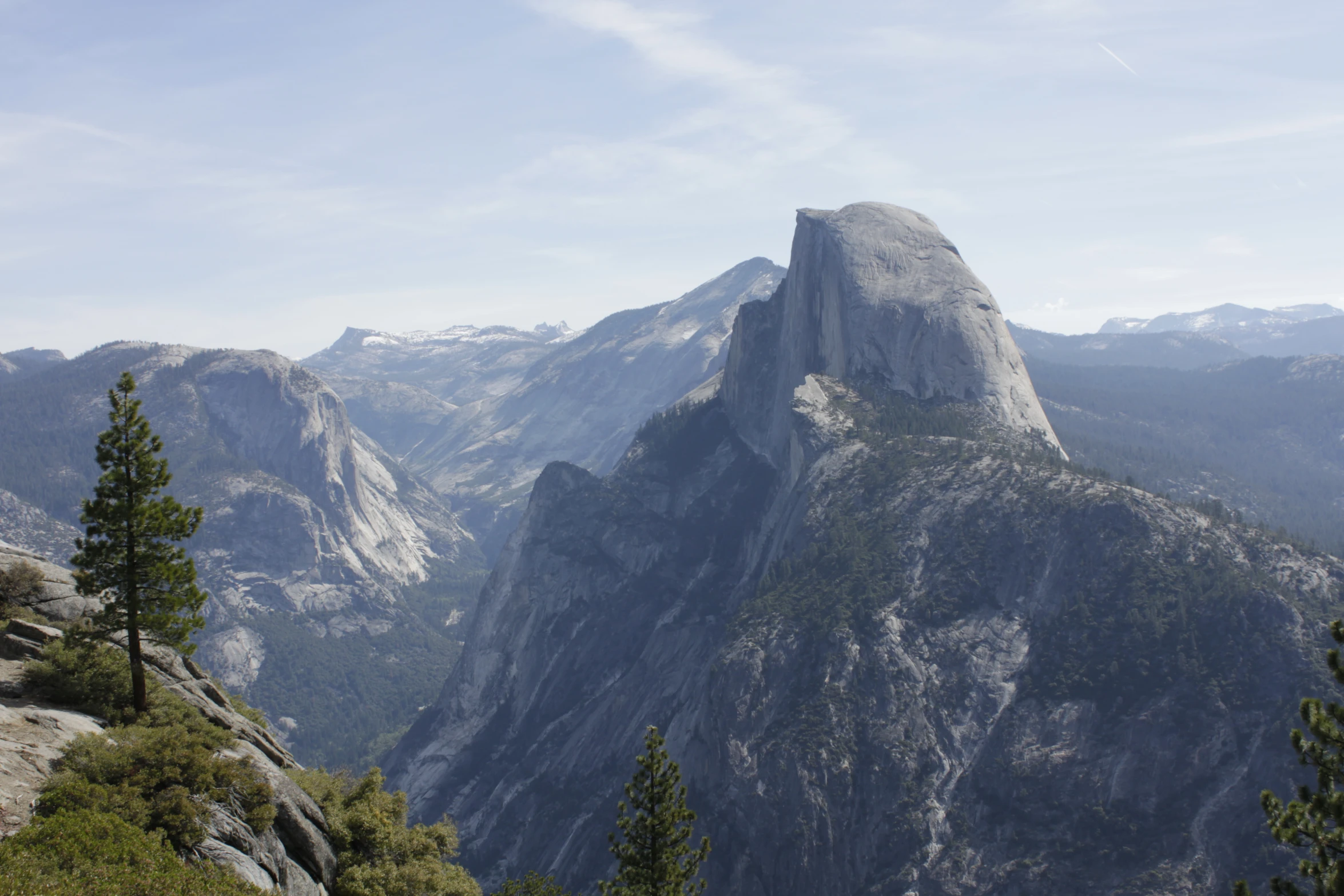 a man is on the edge of a mountain looking at the view