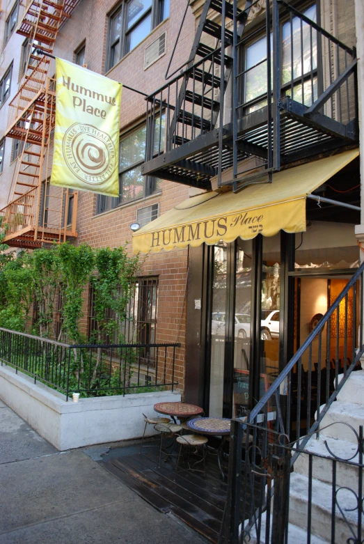 the outside of a restaurant with an orange umbrella