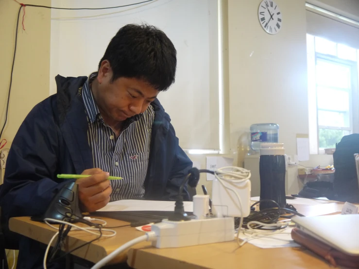 a man sitting at a desk with laptop computer