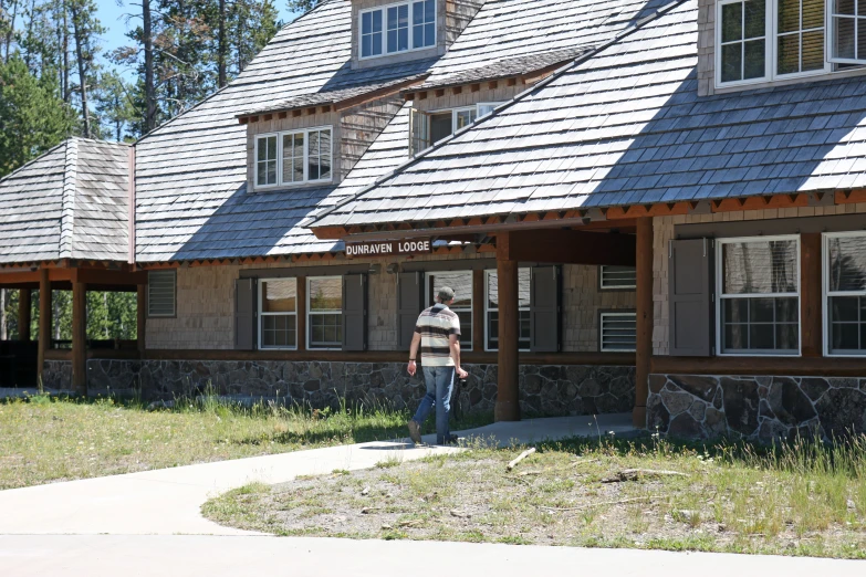 there is a person that is walking in front of a building