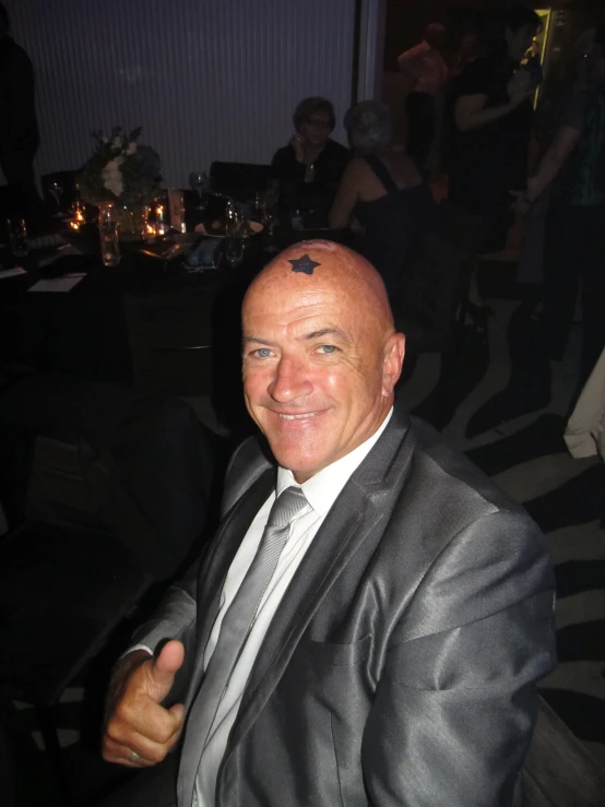 a man with a bald head wearing a suit