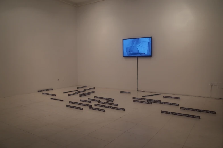 a room with rows of rectangular black objects in front of a television