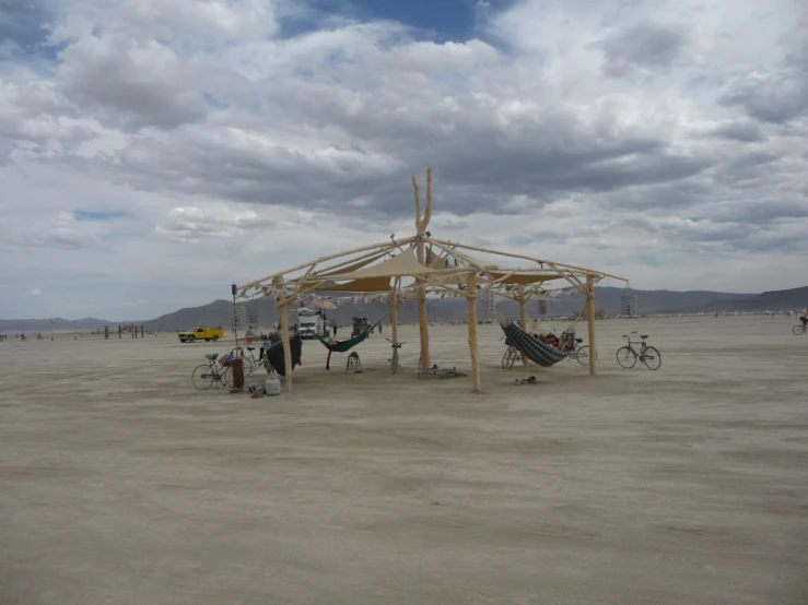 a large tent sits in the middle of a large open field