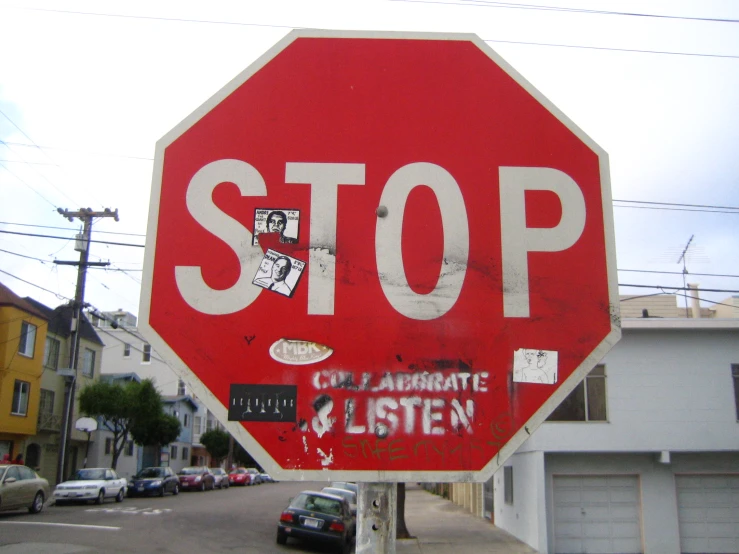 stop sign with a picture on it and graffitti and stickers