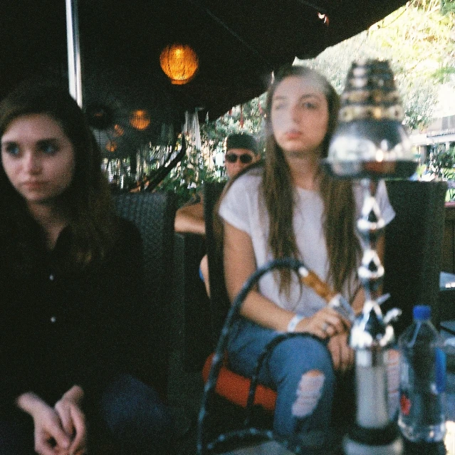 two women sitting down next to each other