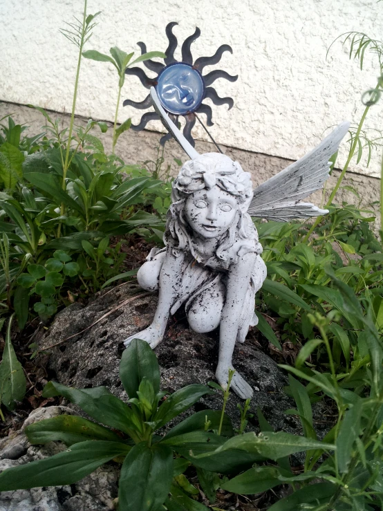 a small statue that looks like the fairy god has fallen to his knees