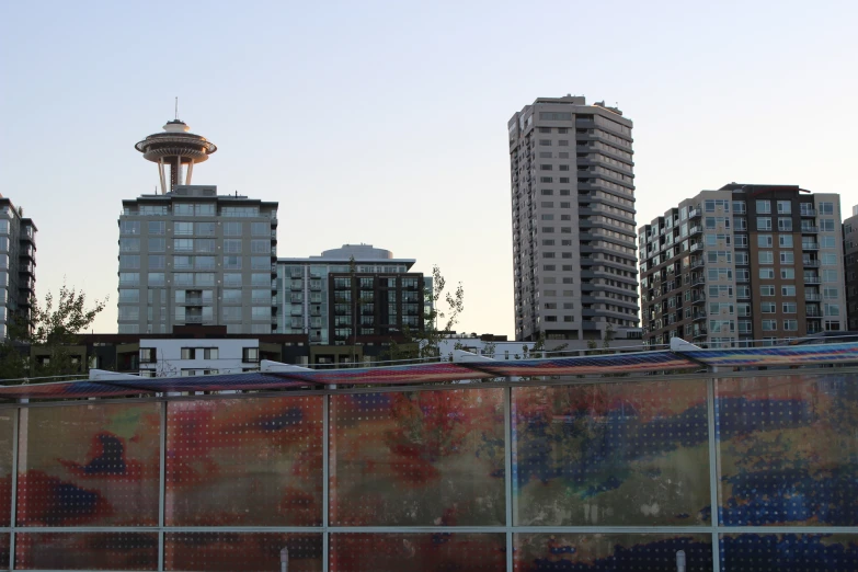 a fence near a city with a building in the background