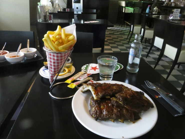 the steak and french fries are prepared on the table