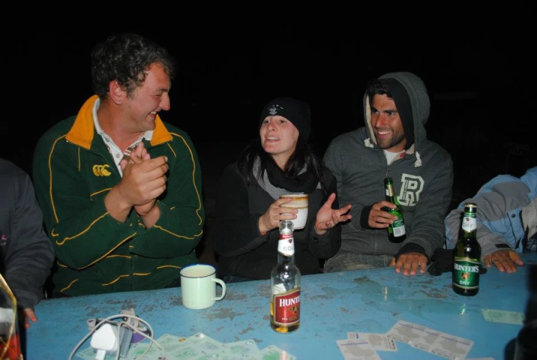 several friends are laughing together at the table