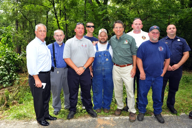 a group of men standing together next to each other