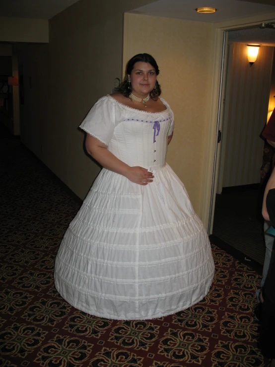 a woman standing in a very large white dress