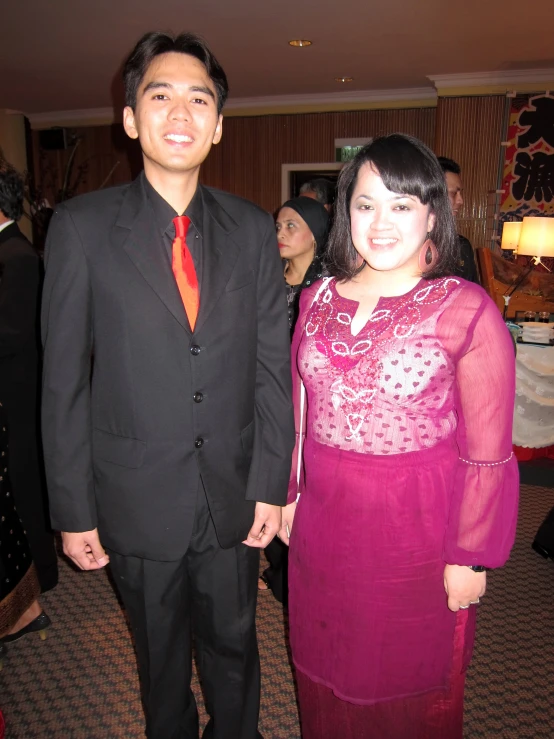 a man and woman dressed in black standing next to each other