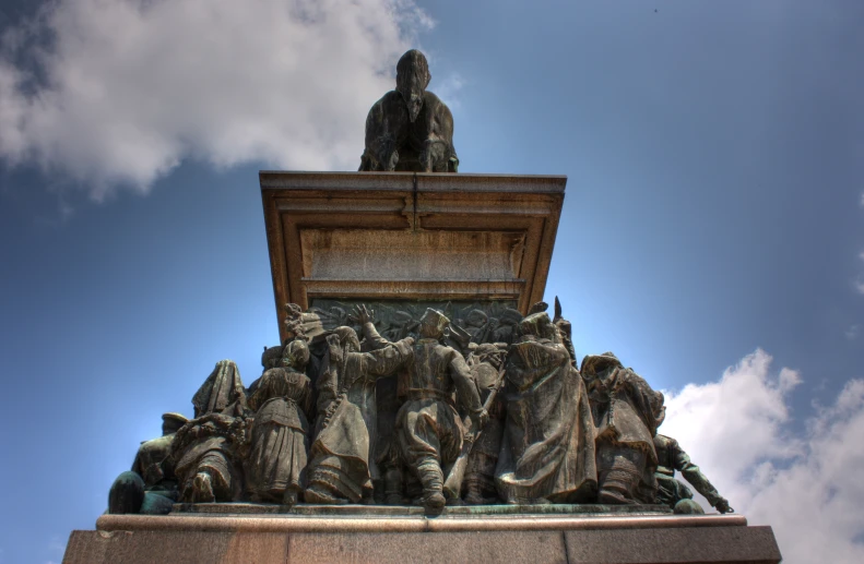 a statue is standing at the top of a tower