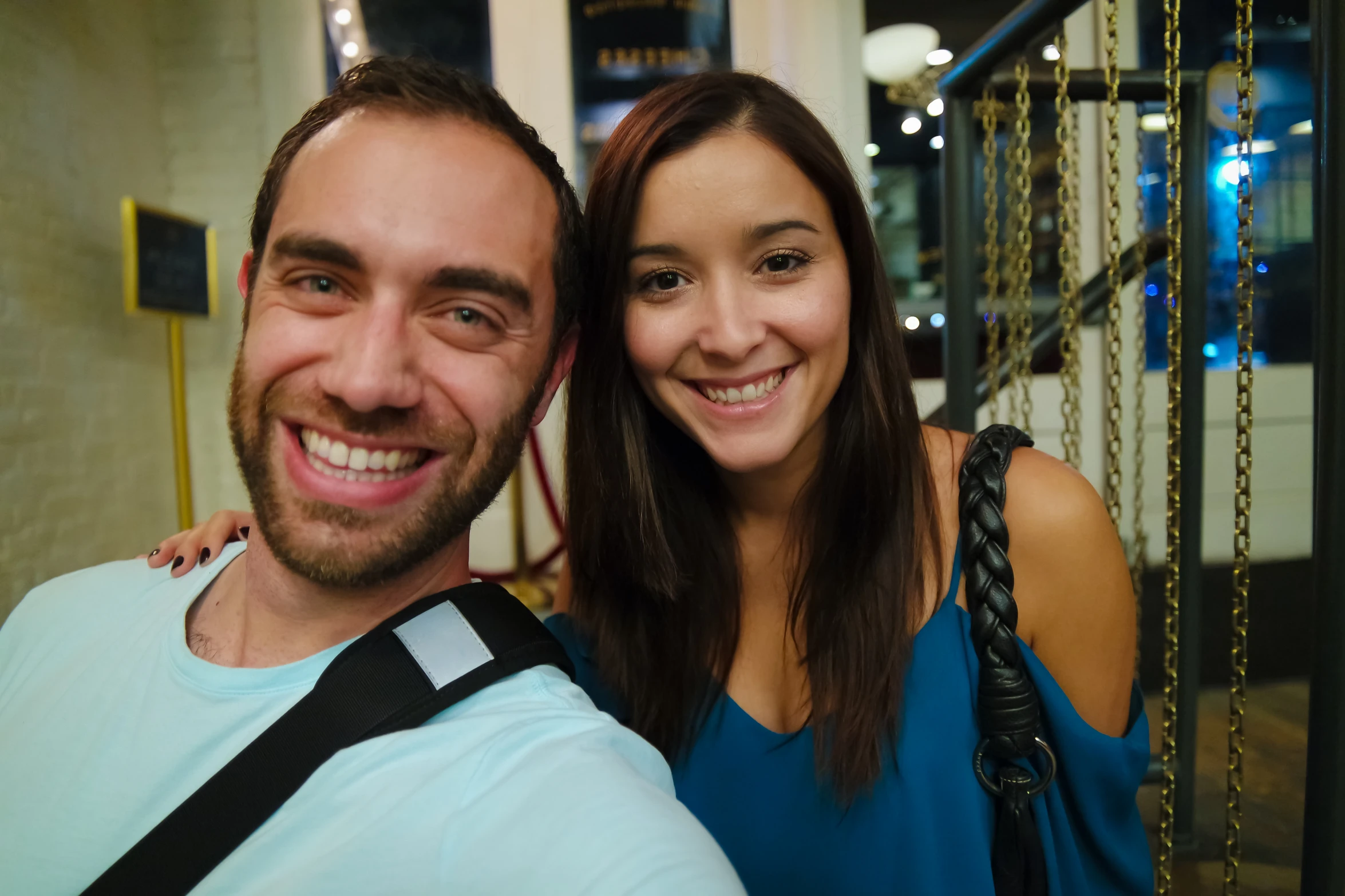 man and woman taking selfie on stairs at night