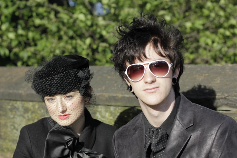 a man and a woman wearing sunglasses posing for a po