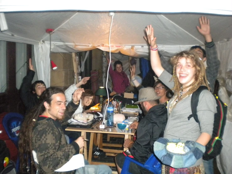 many people at a party in a tent