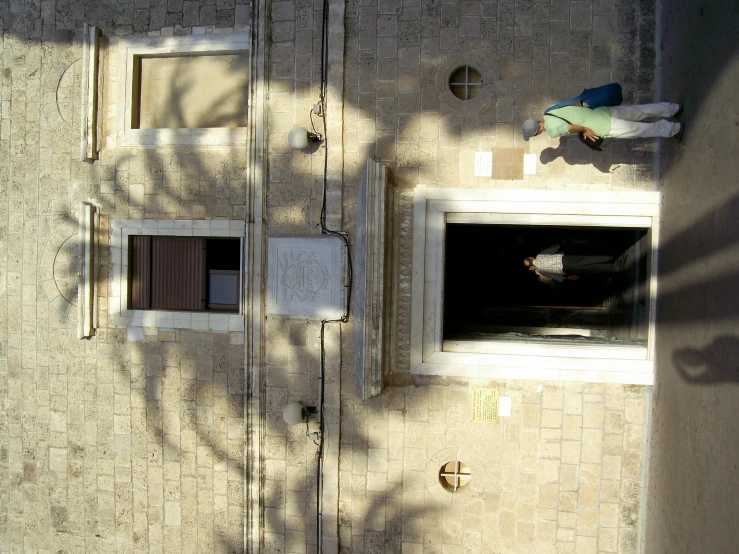 a brick building with the door ajar and windows opened